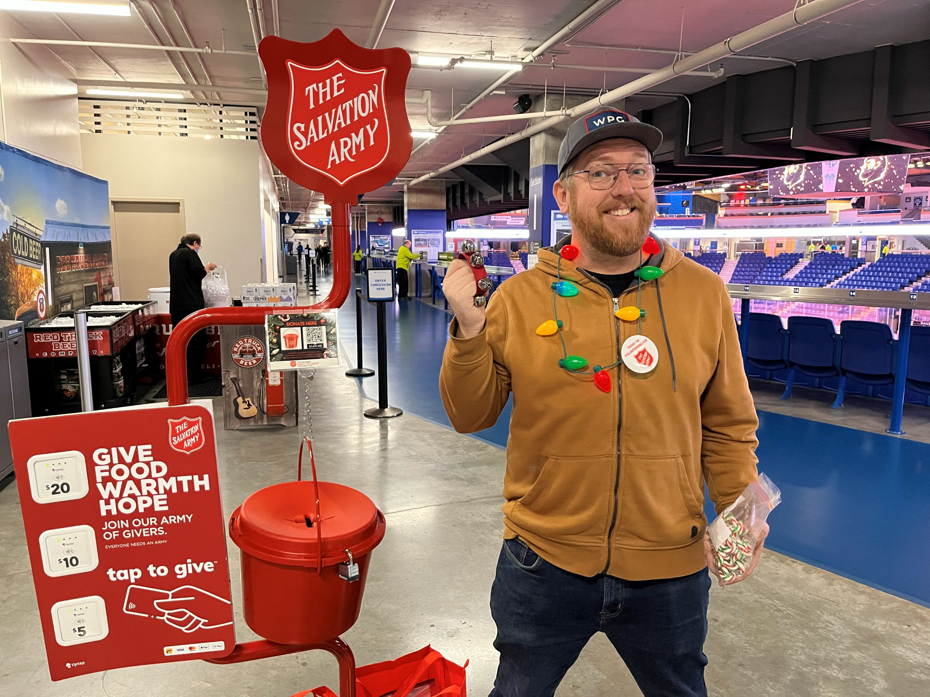 Man fundraising at Salvation Army Christmas kettle